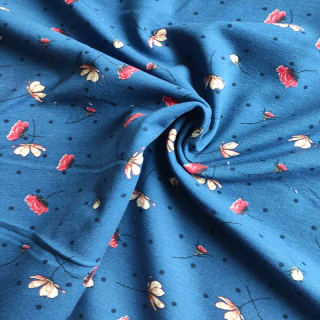 Teplákovina s elastanem kvítka mezi puntíky na modré